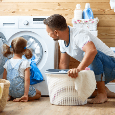 Father and young daughter doing the laundry together